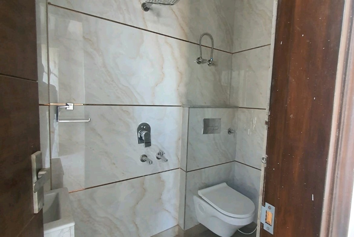 A newly constructed 2 BHK top-floor builder floor in C6B Block Janakpuri featuring 2 washrooms, a roof porta cabin, and an additional roof bathroom.