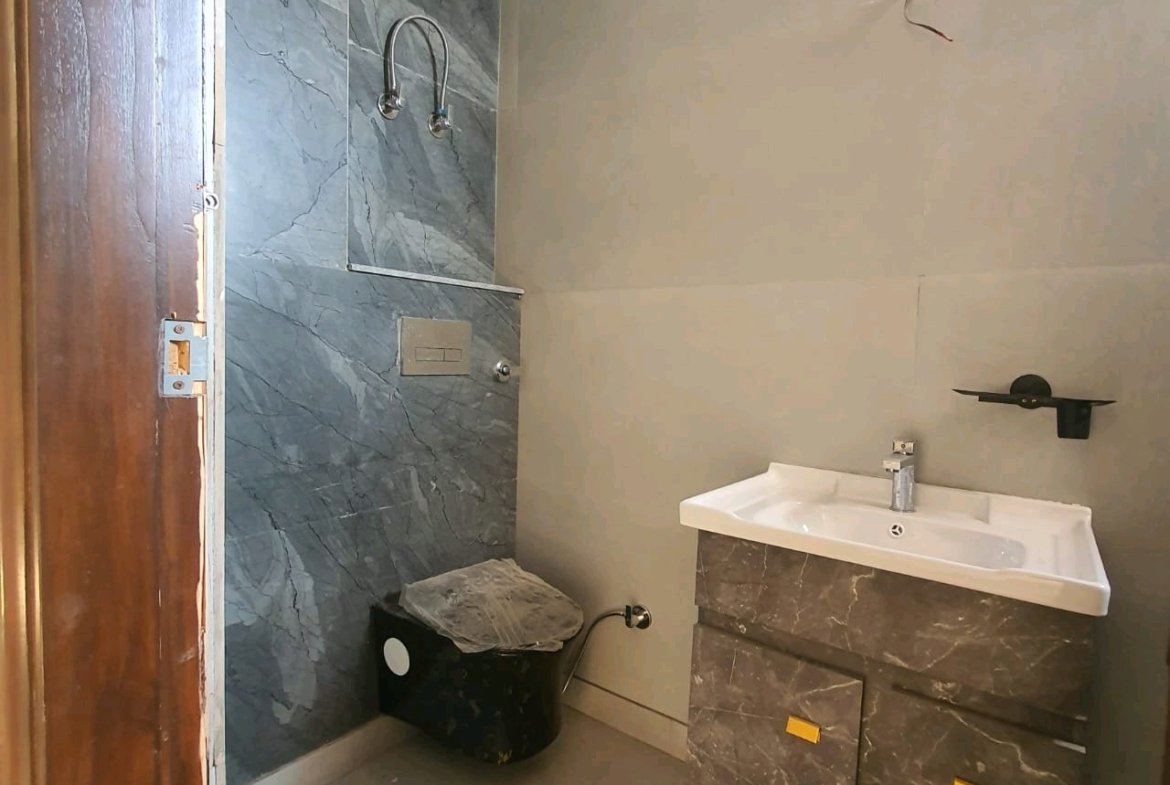 A newly constructed 2 BHK top-floor builder floor in C6B Block Janakpuri featuring 2 washrooms, a roof porta cabin, and an additional roof bathroom.
