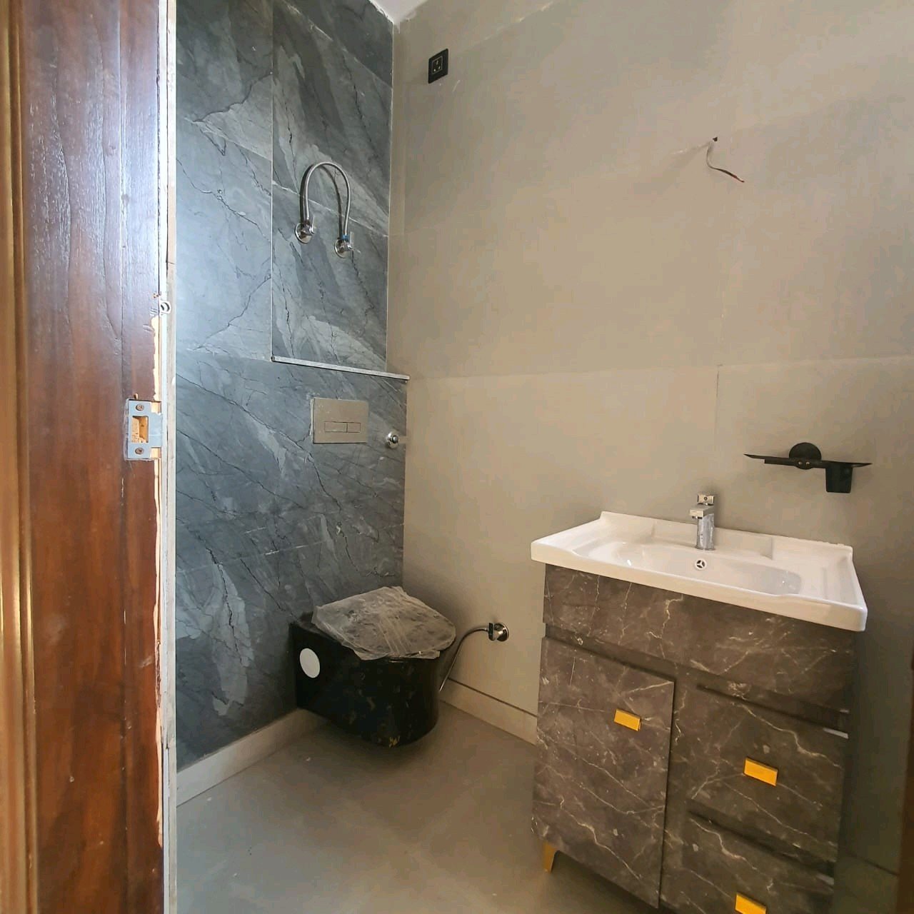 A newly constructed 2 BHK top-floor builder floor in C6B Block Janakpuri featuring 2 washrooms, a roof porta cabin, and an additional roof bathroom.