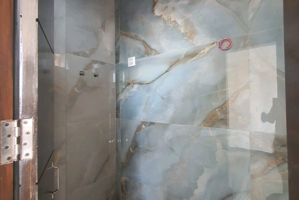 A newly constructed 2 BHK top-floor builder floor in C6B Block Janakpuri featuring 2 washrooms, a roof porta cabin, and an additional roof bathroom.