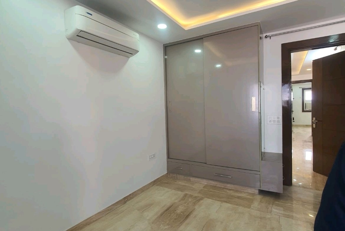 A well-designed 80 gaj top-floor builder floor in C4F Block Janakpuri with roof rights, 2 BHK + 1 room set, ACs fitted, chimney, and corner north-facing advantage.